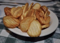a bowl of potato chips on a table