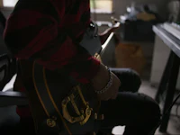 a person playing a guitar in a room