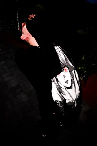 a person holding a skateboard in the dark