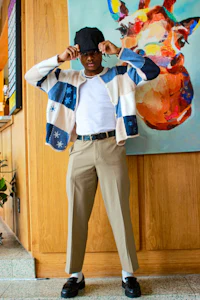 a man is posing in front of a painting