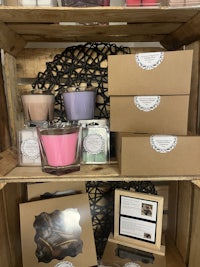 a wooden crate filled with candles and boxes