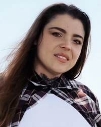 a woman with long hair and a plaid shirt