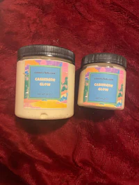 two jars of body butter on a red background