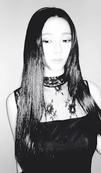 a black and white photo of a woman with long hair