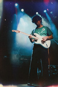 a man playing a guitar on stage