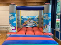 a unicorn bouncy castle in a room