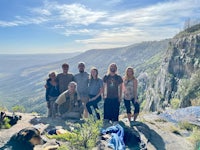 a group of people standing on top of a mountain