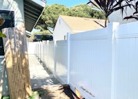 a white vinyl fence in a backyard