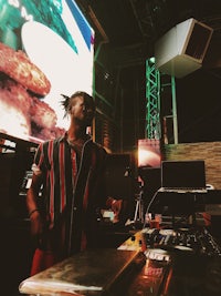 a man standing in front of a large screen