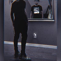 a man standing in front of a mirror