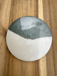 a blue and white plate on a wooden table