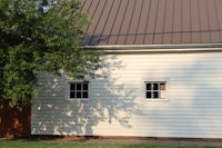 a white building with a tree in front of it