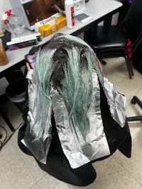 a woman's hair is covered in foil