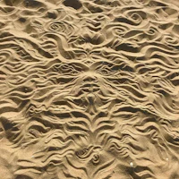 a sand drawing of a face in the sand