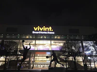 a statue of a basketball player in front of a building at night