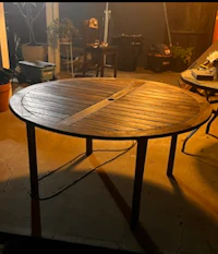 a round wooden table in a garage