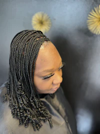 a woman with braided hair in a salon