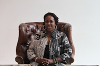 a black woman sitting in a leather chair