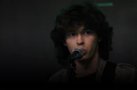 a young man singing into a microphone