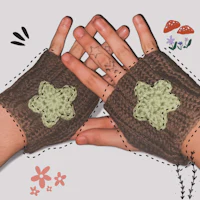 a pair of crocheted fingerless mitts with flowers on them