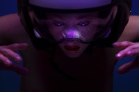 a woman in a helmet with purple lights on her face