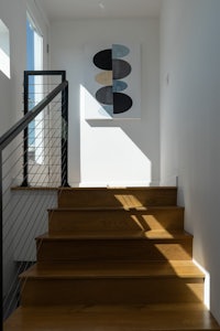 a staircase in a home with a painting on the wall