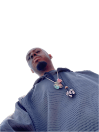 a man wearing a hoodie and a necklace