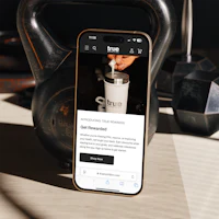 a phone with a kettlebell next to it on a table