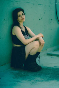 a girl is sitting on the ground