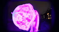 an image of a purple light sculpture in a dark room