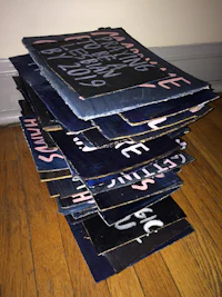 a stack of blue and pink t-shirts on a wooden floor