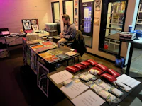 a man sitting at a table with a lot of books