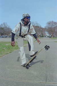 a man riding a skateboard on a sidewalk