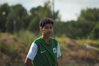 a young man is standing on a soccer field