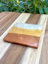 a ceramic coaster sitting on top of a wooden table