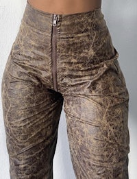 a woman wearing brown leather pants