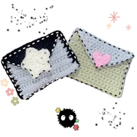 two crocheted envelopes with stars on them