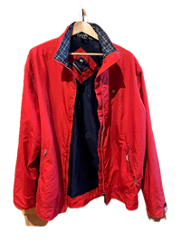 a red jacket hanging on a hanger