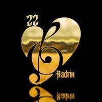 a gold heart with a musical note in the middle