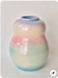 a small vase with a pink, blue, and green glaze