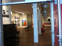 a doorway to an art gallery with a piano