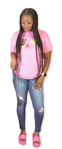 a woman wearing a pink t - shirt and jeans