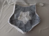 a crocheted star blanket on a bed