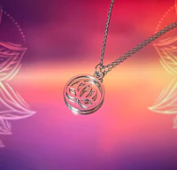 a silver necklace with a lotus flower on it