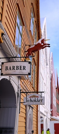 a barber shop sign with a horse on it