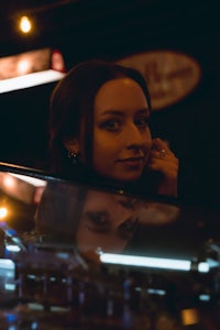 a woman is looking at herself in the mirror