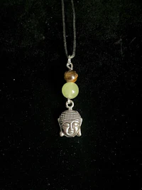 a necklace with a buddha head on it