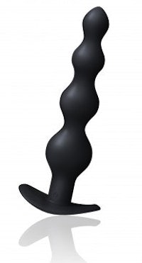 a black sex toy on a white surface