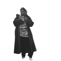 a black and white photo of a woman in a coat