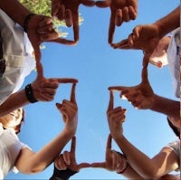 a group of people making a cross with their hands